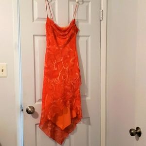 Latin dance dress in vibrant orange, hi-low hem, sheer with liner